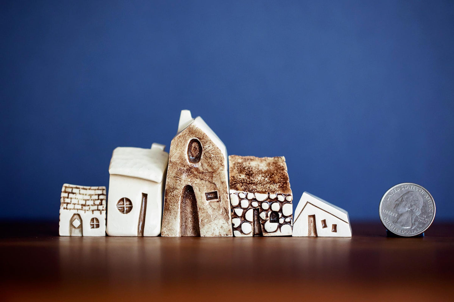 Miniature Amsterdam ceramic houses with cobblestone and stucco texture.