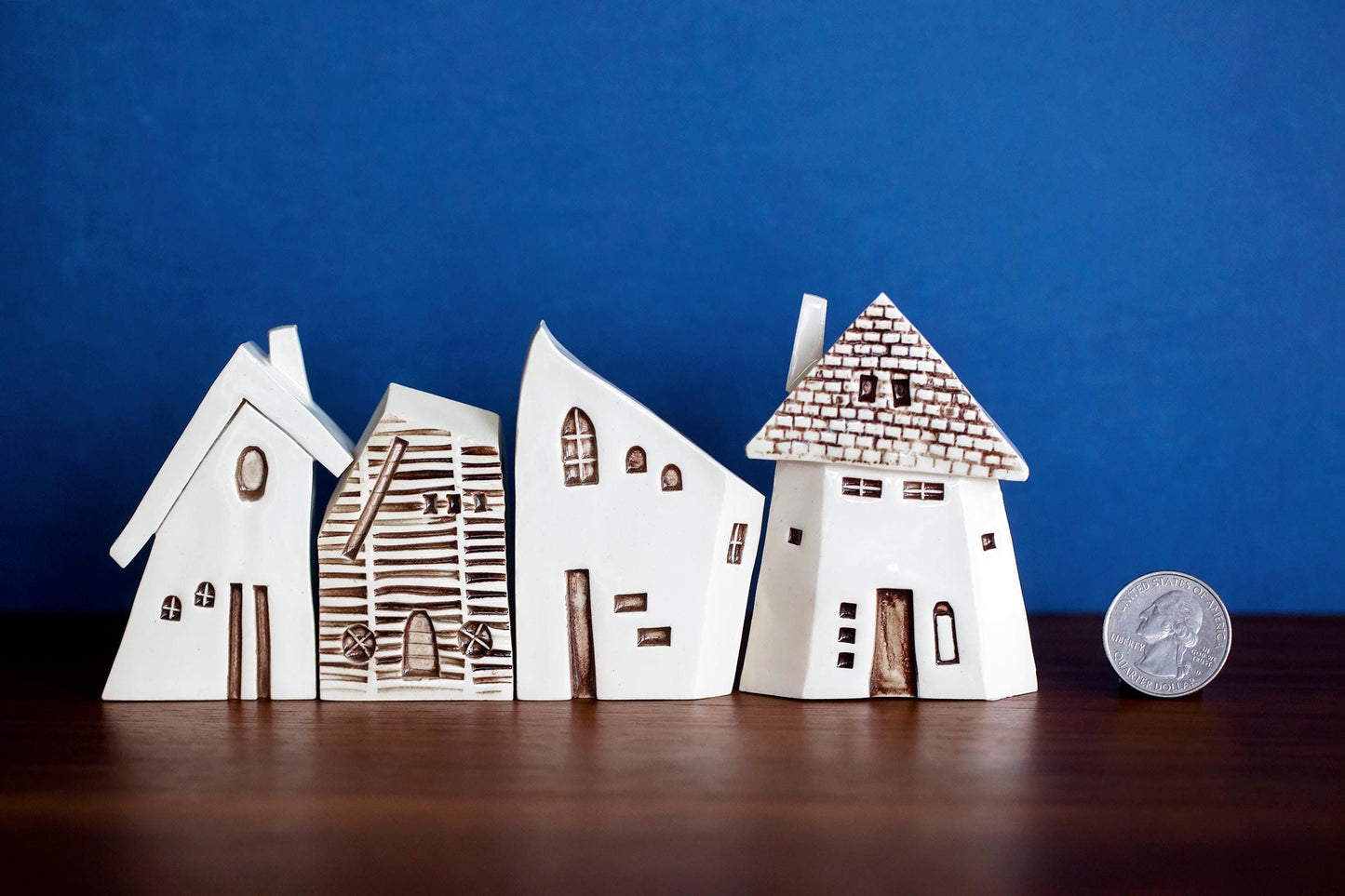 Bruges style white ceramic houses village with brick and whimsical details.