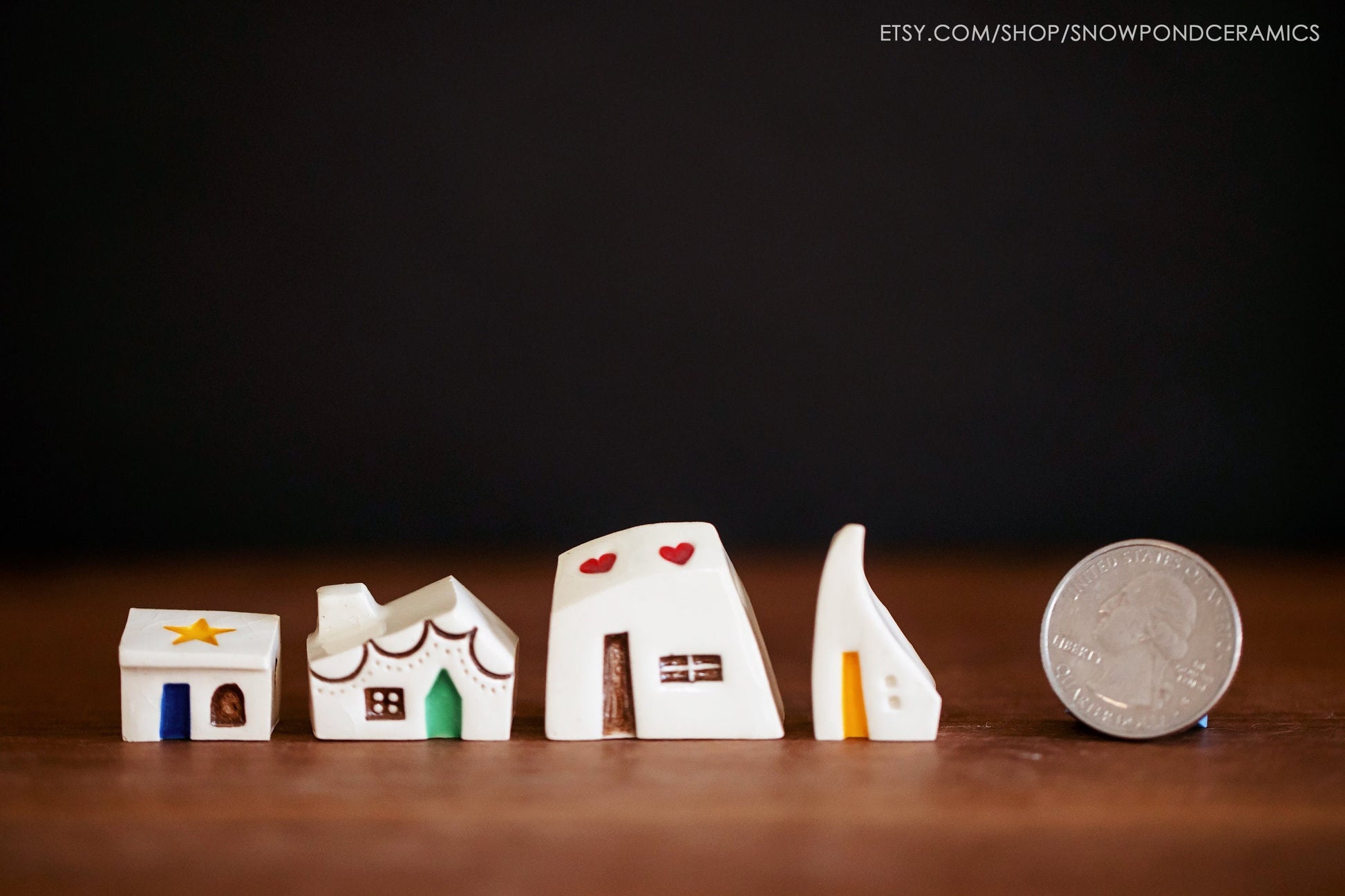 Whimsical ceramic houses with stars, hearts and colorful doors.