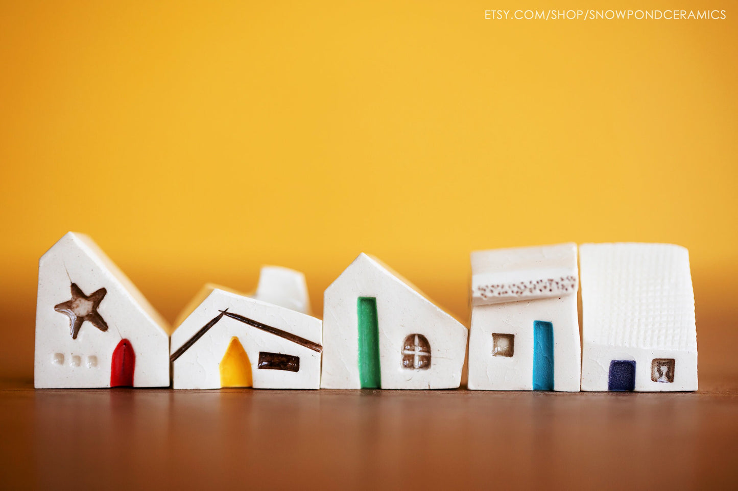 Whimsical set of tiny white ceramic houses as get well gift with rainbow doors.