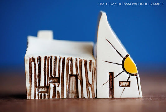 Miniature ceramic cabin with sunshine house, made in Missouri.