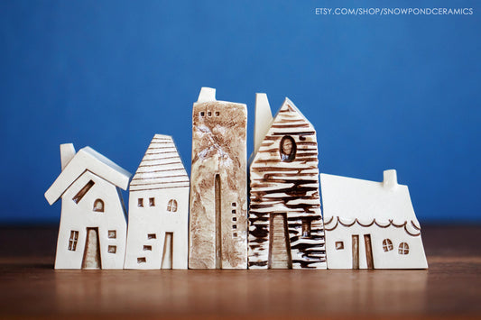 A set of five small ceramic houses modeled after the houses in Amsterdam and Bruges.