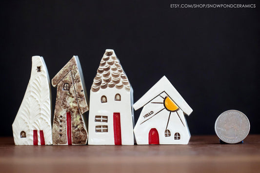 Miniature ceramic houses with sunshine and owl.