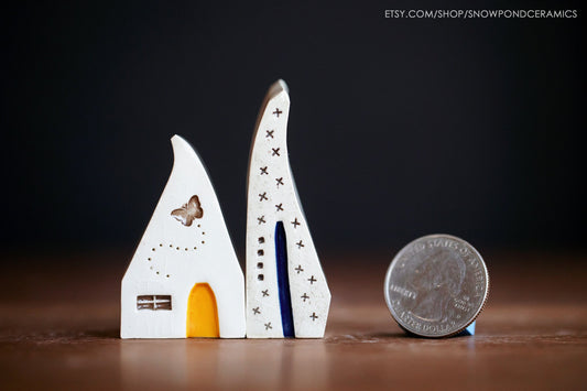 Tiny ceramic houses with butterfly and stars.