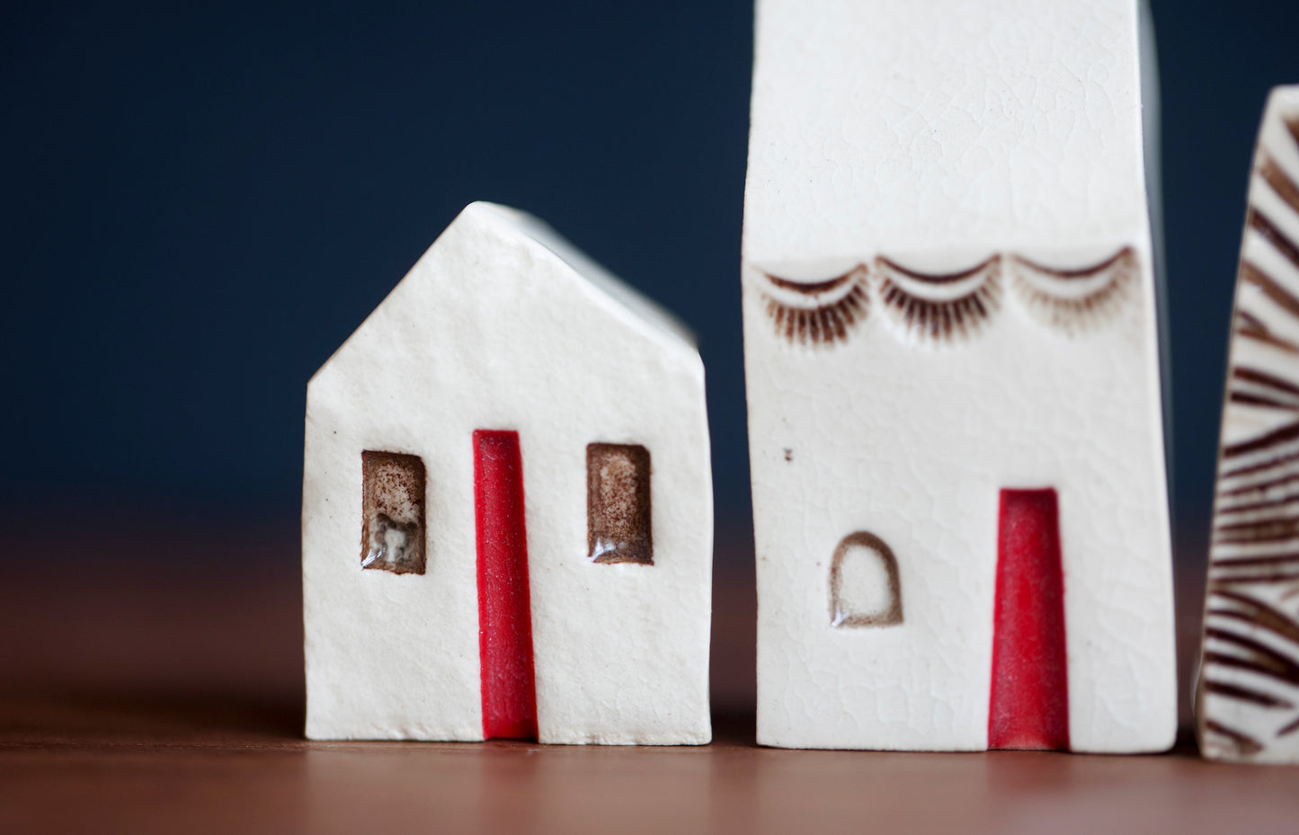 Artsy Ceramic Village with Red Doors and Cat in Window