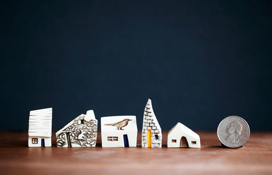Whimsical Ceramic Village with a Raven Bird