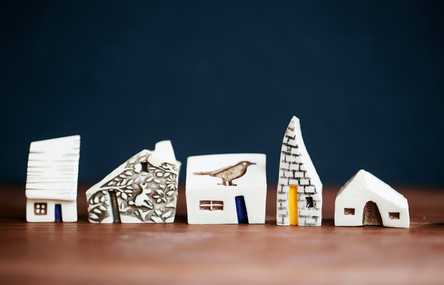 Whimsical Ceramic Village with a Raven Bird