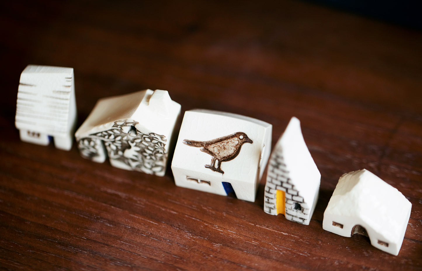 Whimsical Ceramic Village with a Raven Bird
