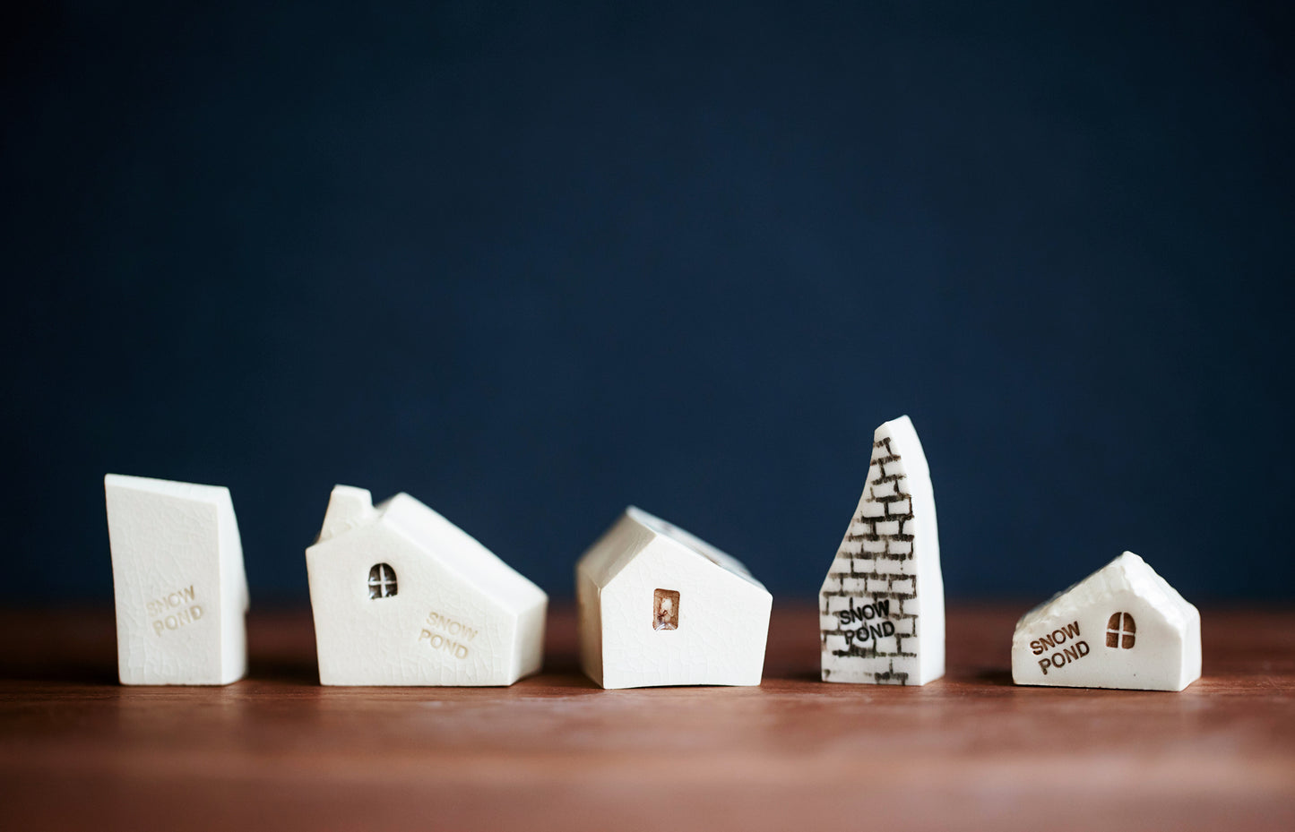 Whimsical Ceramic Village with a Raven Bird