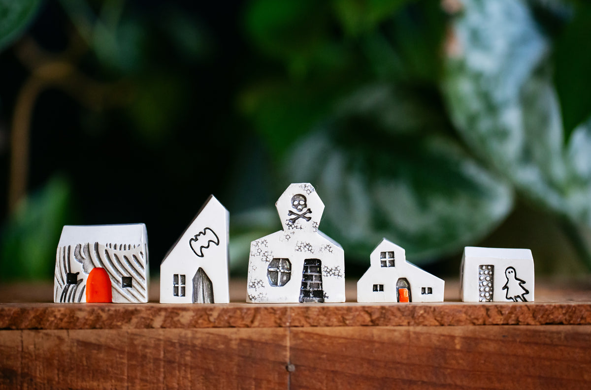Haunted White Ceramic Houses with Skull and Crossbones
