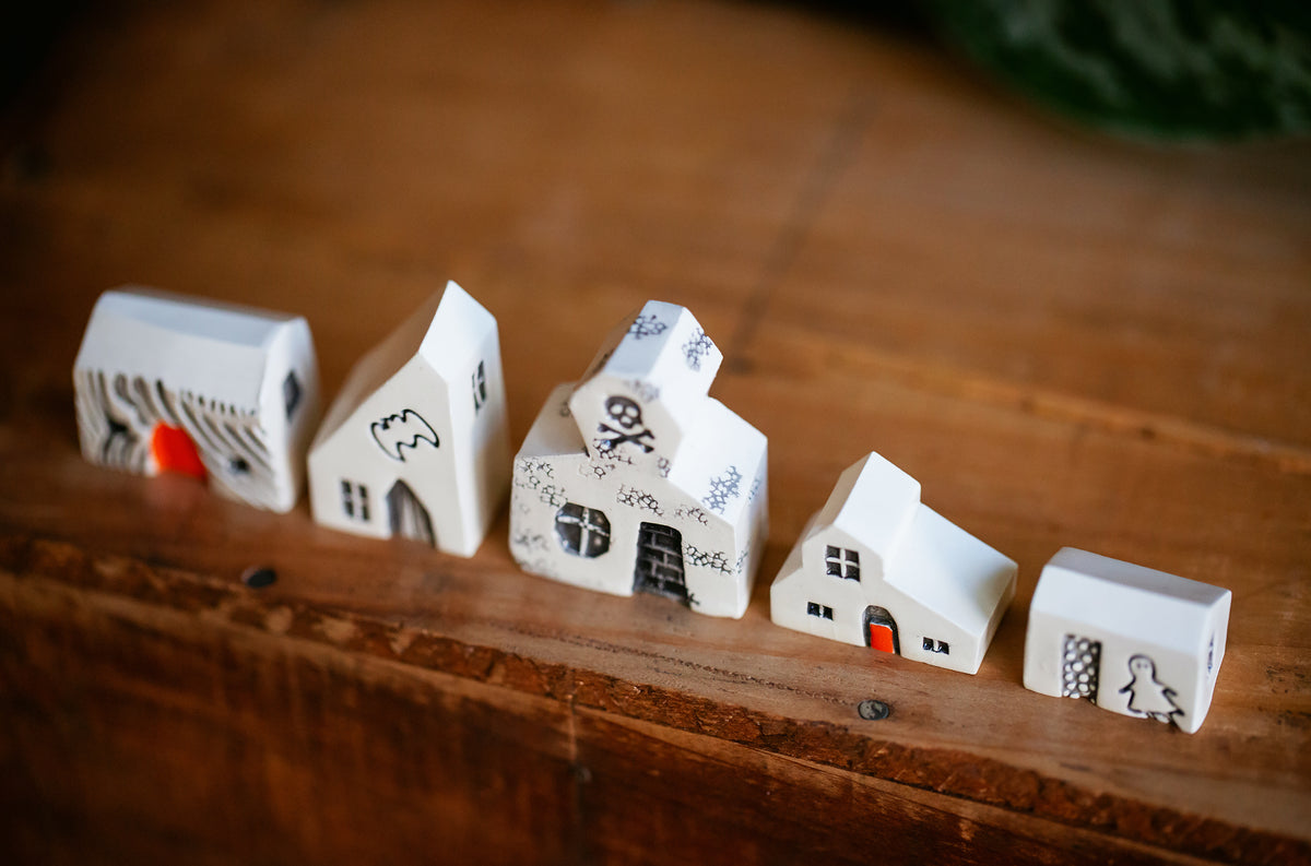 Haunted White Ceramic Houses with Skull and Crossbones