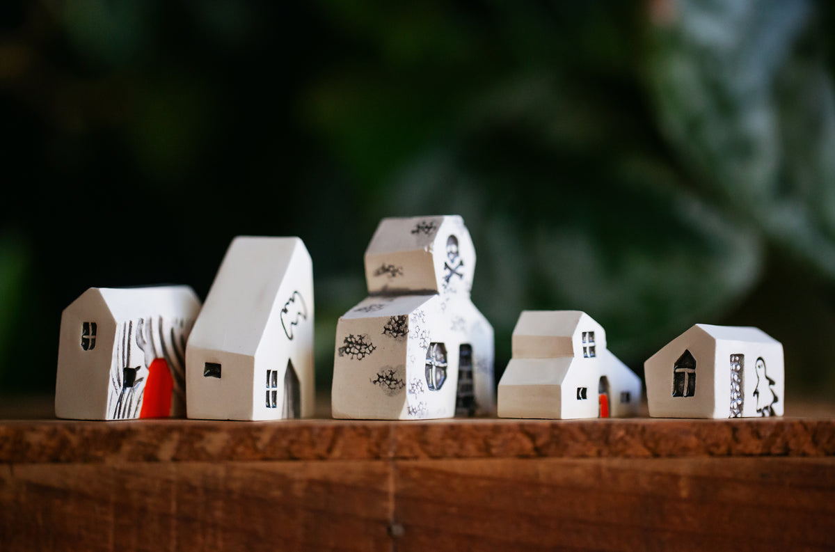 Haunted White Ceramic Houses with Skull and Crossbones