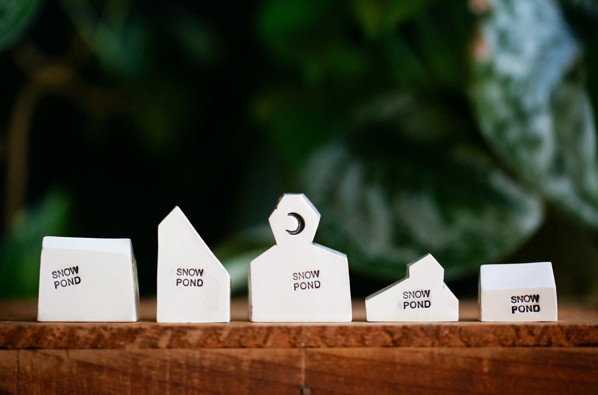 Haunted White Ceramic Houses with Skull and Crossbones